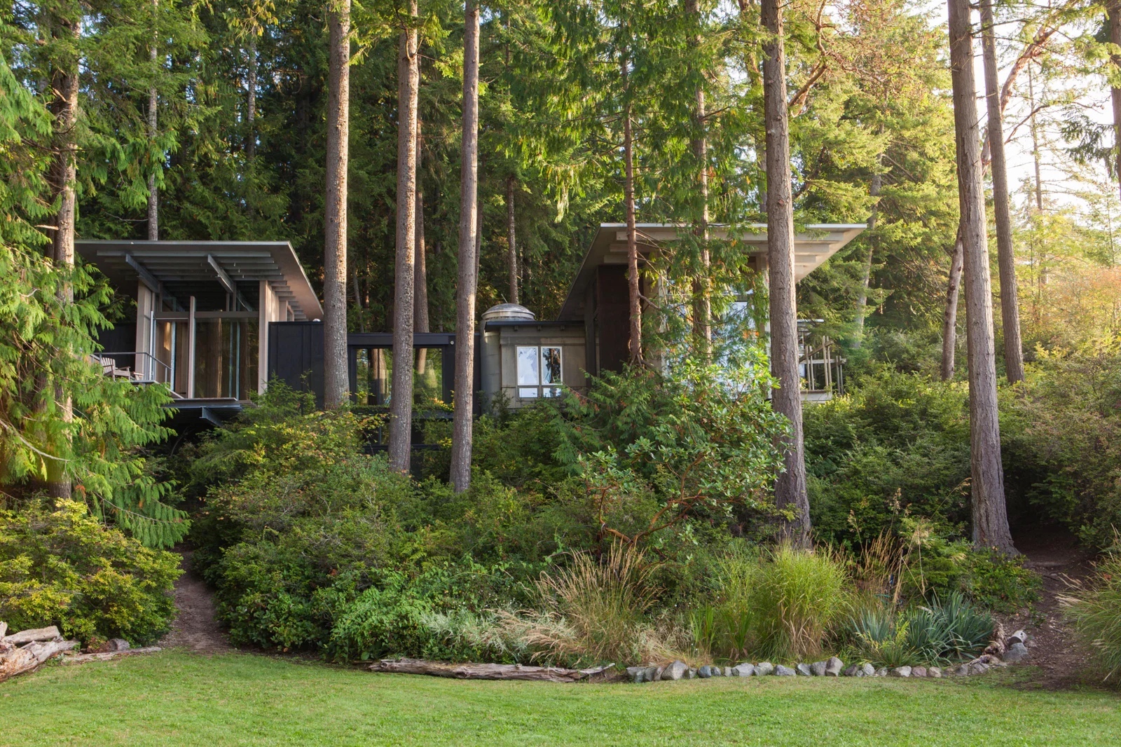 Un cottage nella foresta acquistato nel 1912, ampliato con annessioni diverse volte fino al progetto di ristrutturazione di Olson Kundig. Longbranch, Washington.